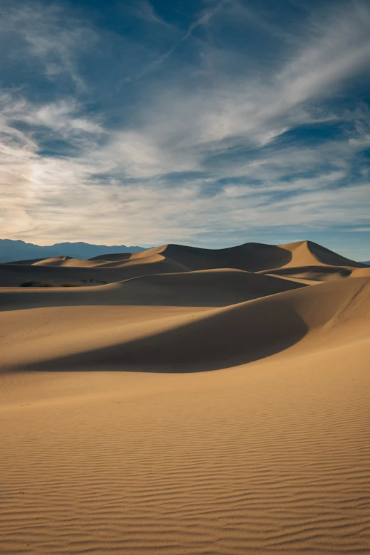 Golden desert dunes at sunset