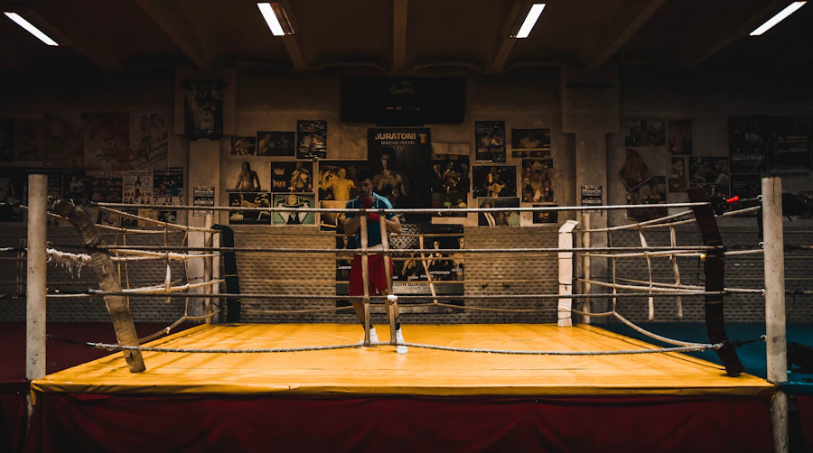 Empty boxing ring under bright arena spotlights