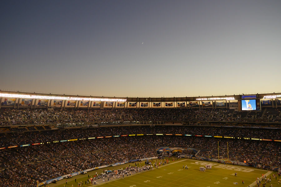 American football stadium filled with fans at night