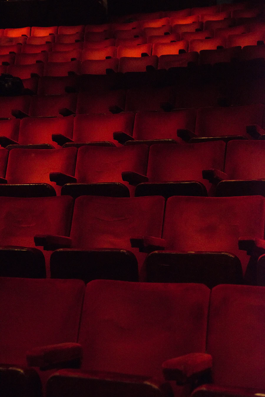Red cinema seats in a dark movie theater